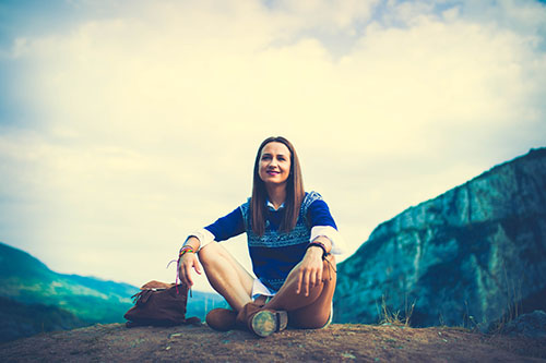 Young woman sitting outdoors natural setting